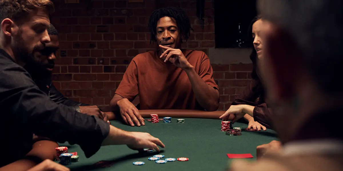 Poker players sitting around a table with chips in play – illustrating variance and the emotional side of bad beats.
