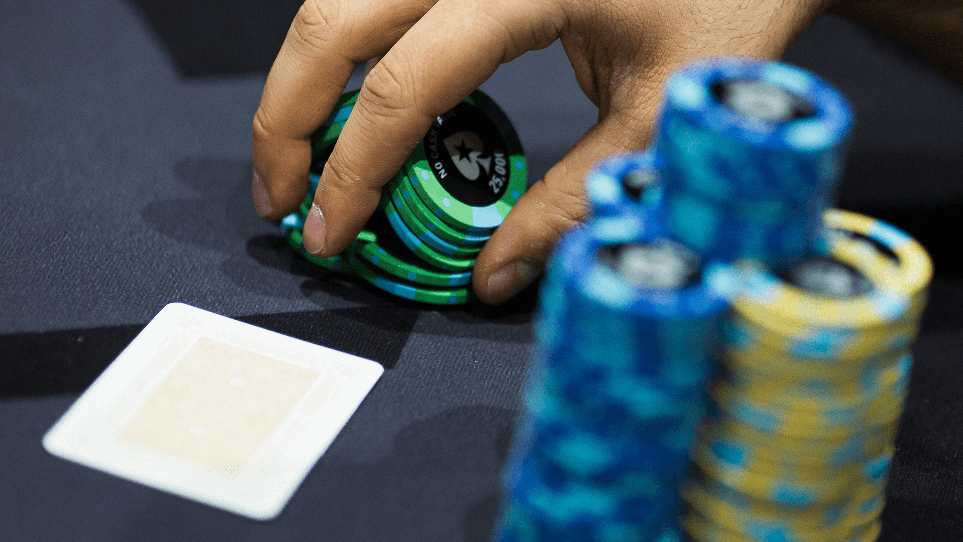 Shuffling green poker chips