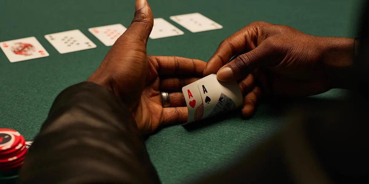 Pocket aces in hand with the board visible in the background, example of a classic bad beat situation.