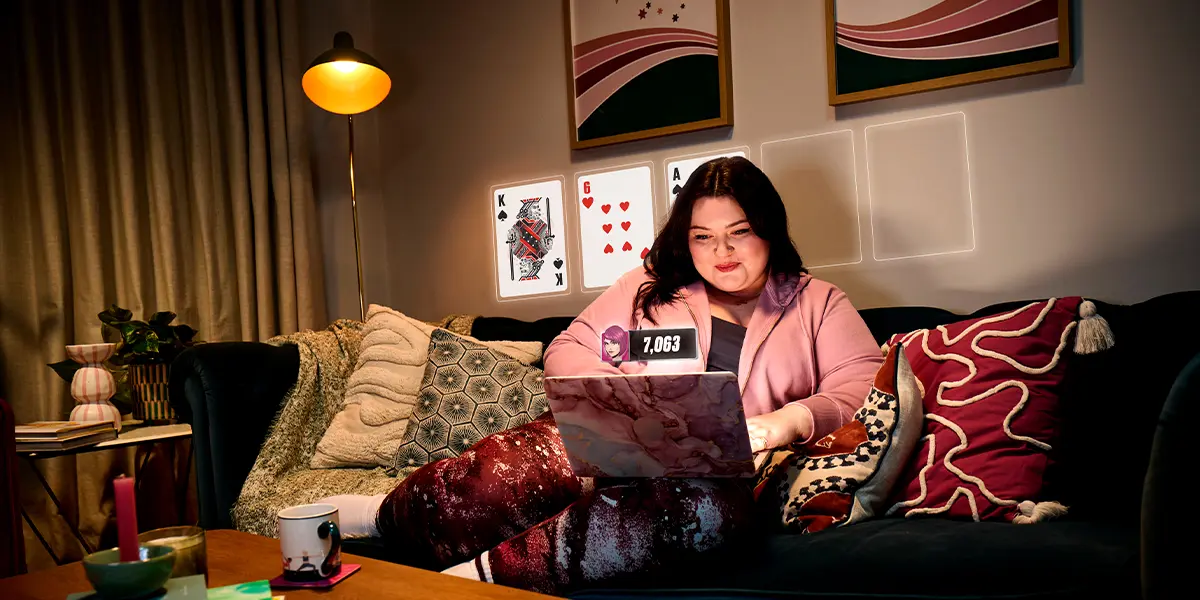A poker player analyzing hand histories and strategy on a laptop screen.