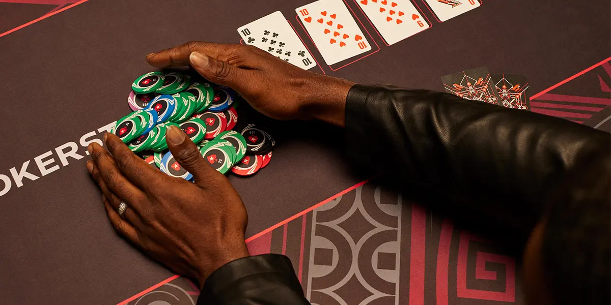 Poker player collecting the pot after a successful turn bet.