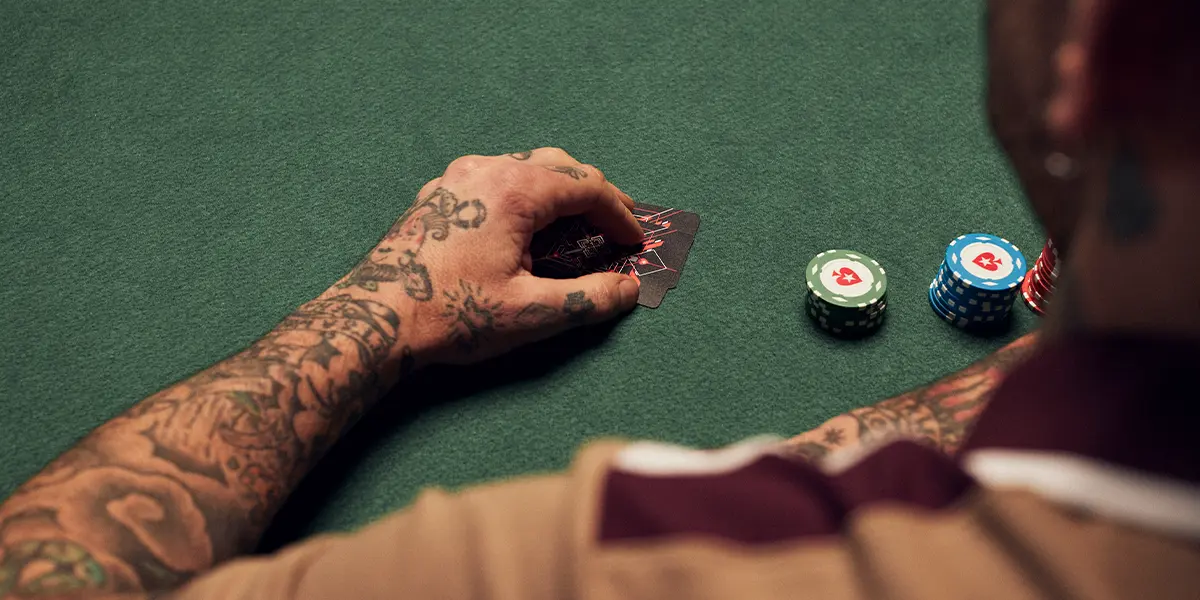 Poker player considering a donk-bet with a vulnerable hand on a low paired flop