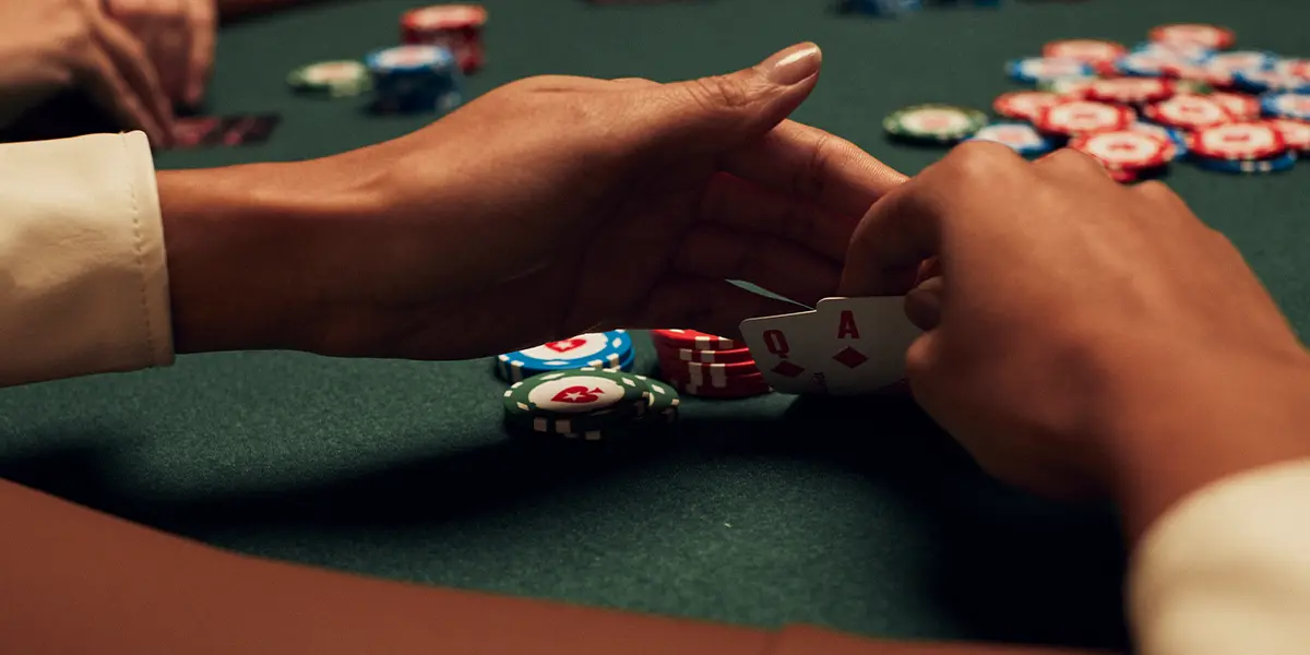 Poker Player holding ace-queen suited, planning their next strategic move.