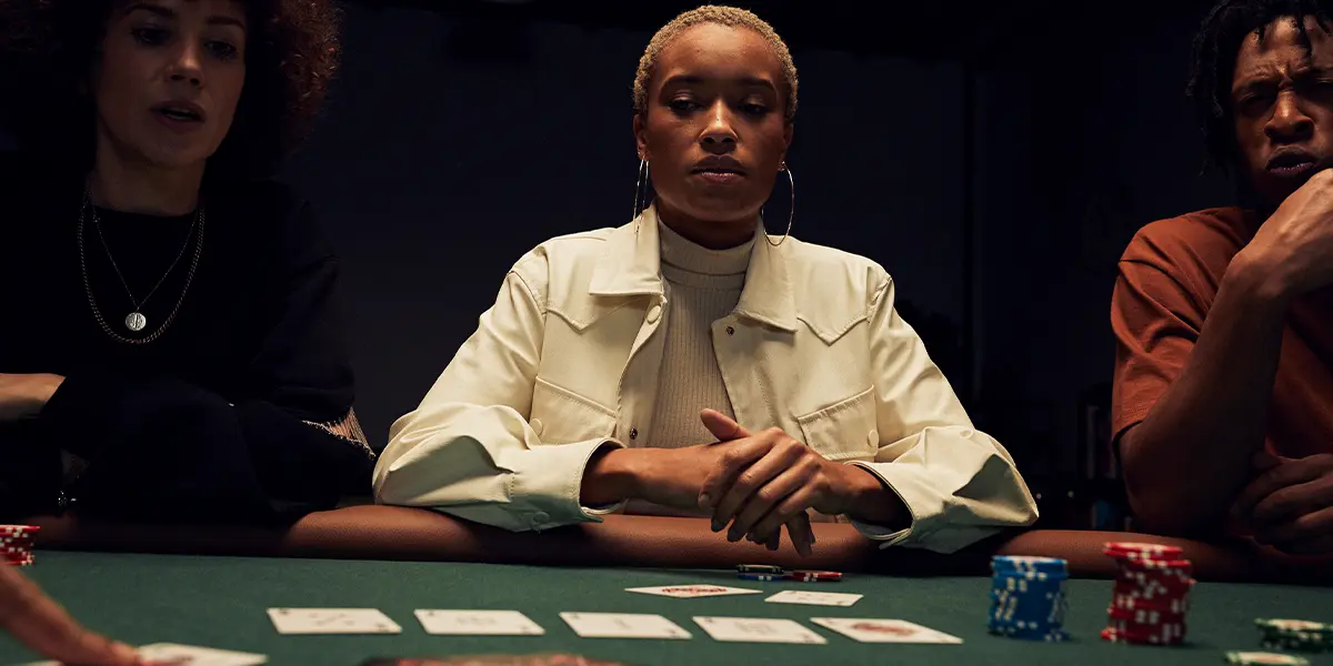 A poker player sitting at the table, deeply focused and thinking about their next move. 
