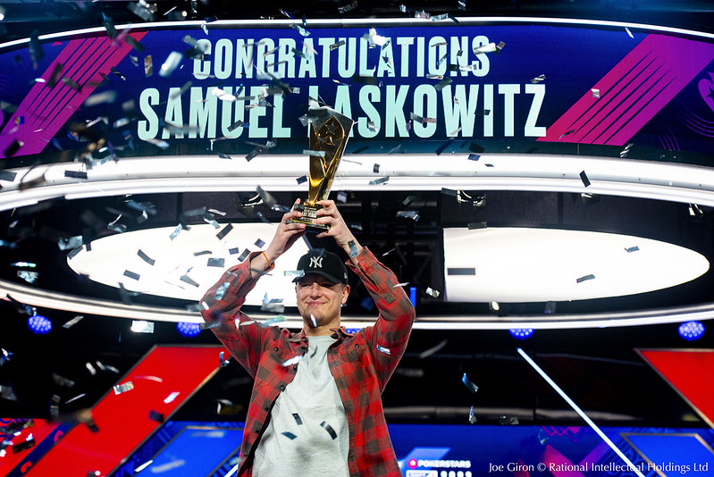Samuel Laskowitz holding aloft the trophy he won at a PokerStars live event