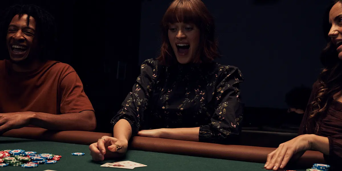 Poker player revealing her hole cards at showdown at the end of a hand.
