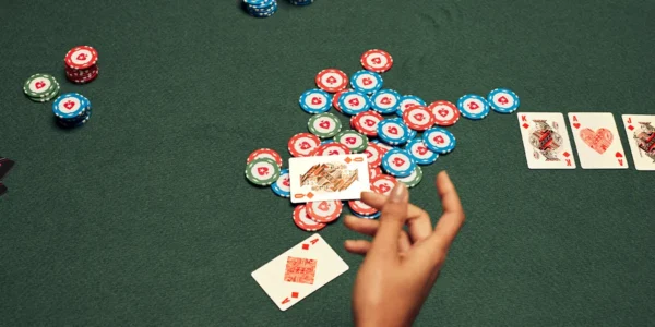 Poker player winning a big pot with a flopped flush