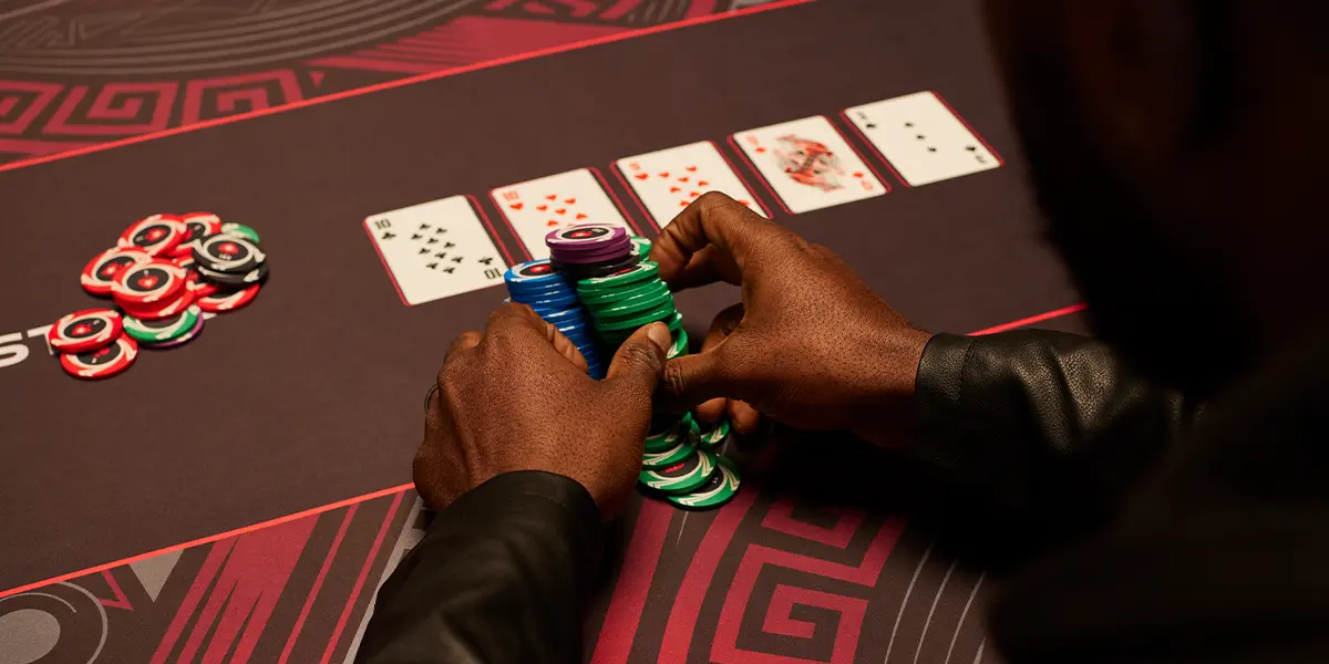 Chips in the center of a poker table representing aggressive betting.